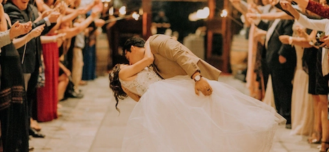 Two married people kissing while dancing